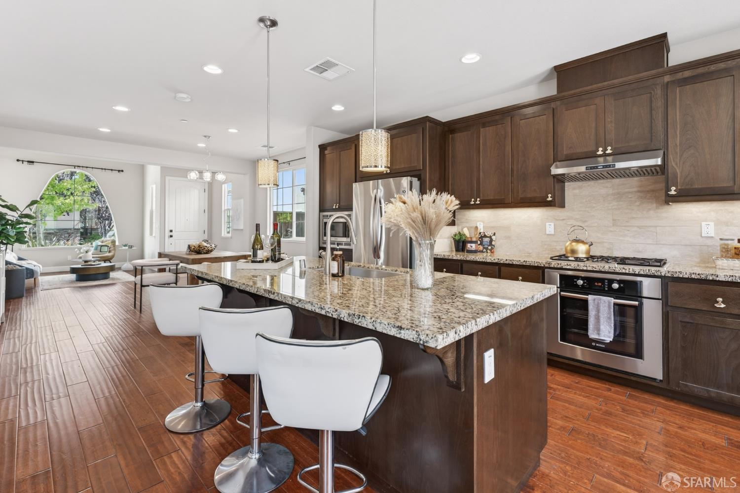 360 Gerald Circle Milpitas, CA 95035 - Photo 13 of 46 a kitchen with stainless steel appliances granite countertop a stove a sink a refrigerator and a dining table with wooden floor
