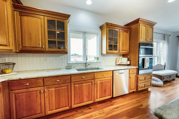 a living room with wooden floor and a fireplace