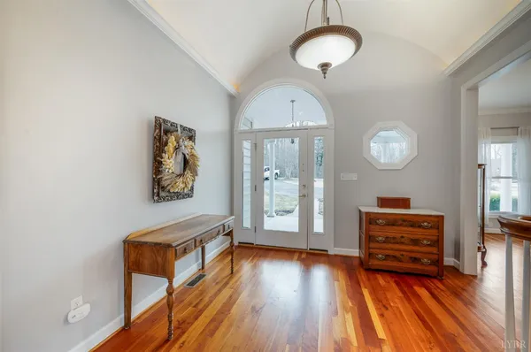 a view of a hallway with entryway wooden floor and front door