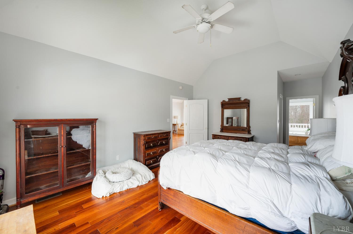 216 Burford Farm Road Monroe, VA 24574 - Photo 29 of 80 a spacious bedroom with a bed and a flat tv screen on dresser