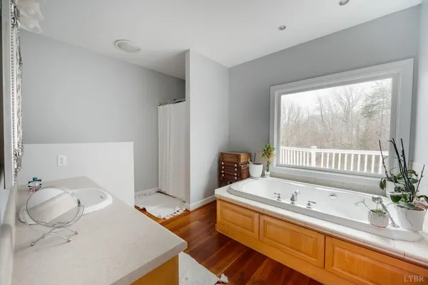 a bedroom with a bed and wooden floors