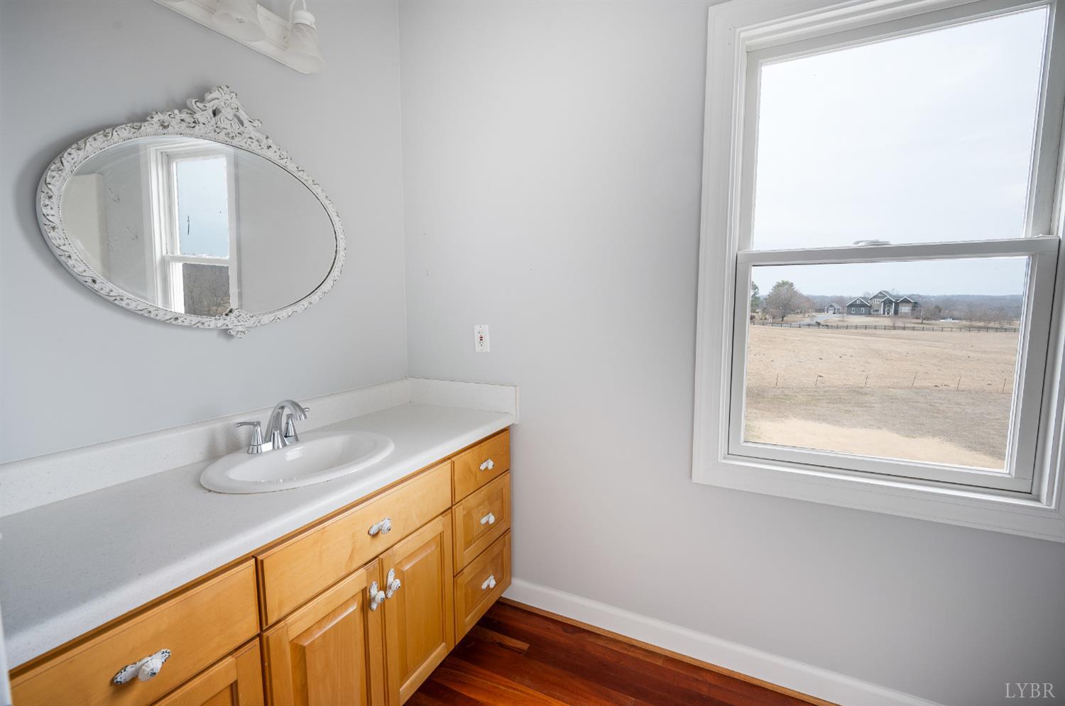 216 Burford Farm Road Monroe, VA 24574 - Photo 41 of 80 a bathroom with a sink a mirror and a window