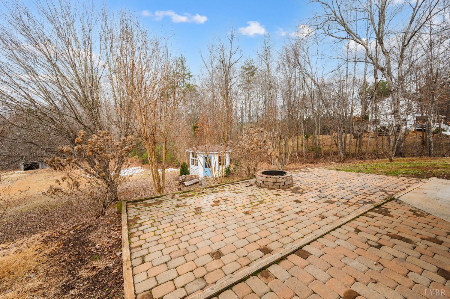 216 Burford Farm Road Monroe, VA 24574 - Photo 60 of 80 a view of a yard with trees in the background
