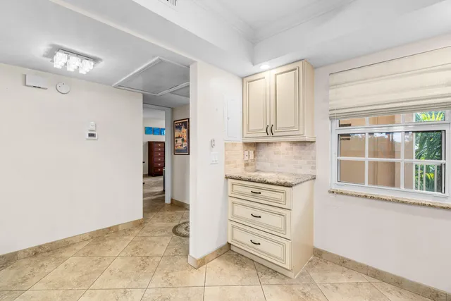 a kitchen with cabinets and window