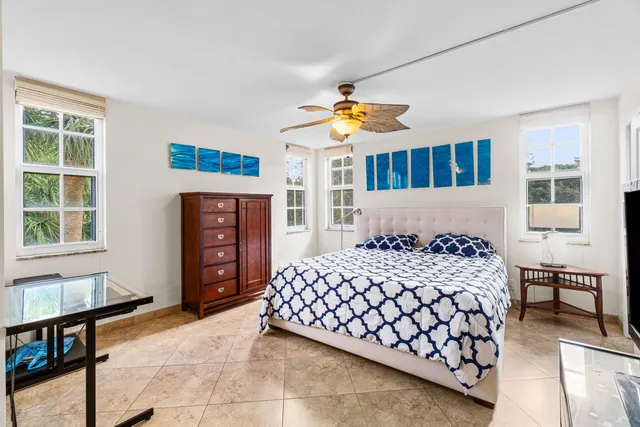 a bedroom with a bed dresser and a window