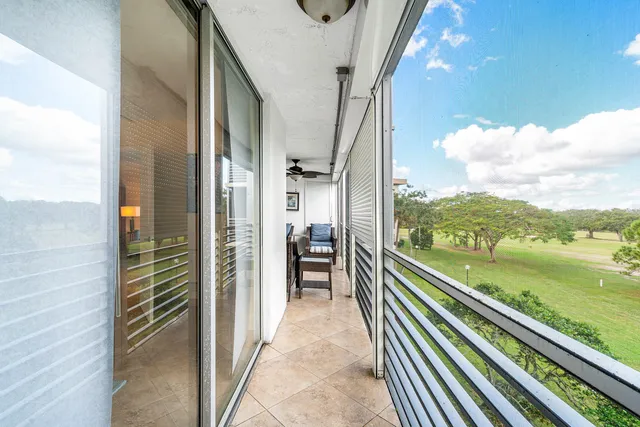 a view of a balcony with floor to ceiling windows with wooden floor