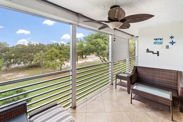 a view of a porch with furniture and wooden floor