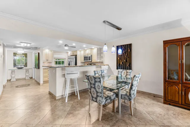 a dining area with furniture and a view of kitchen