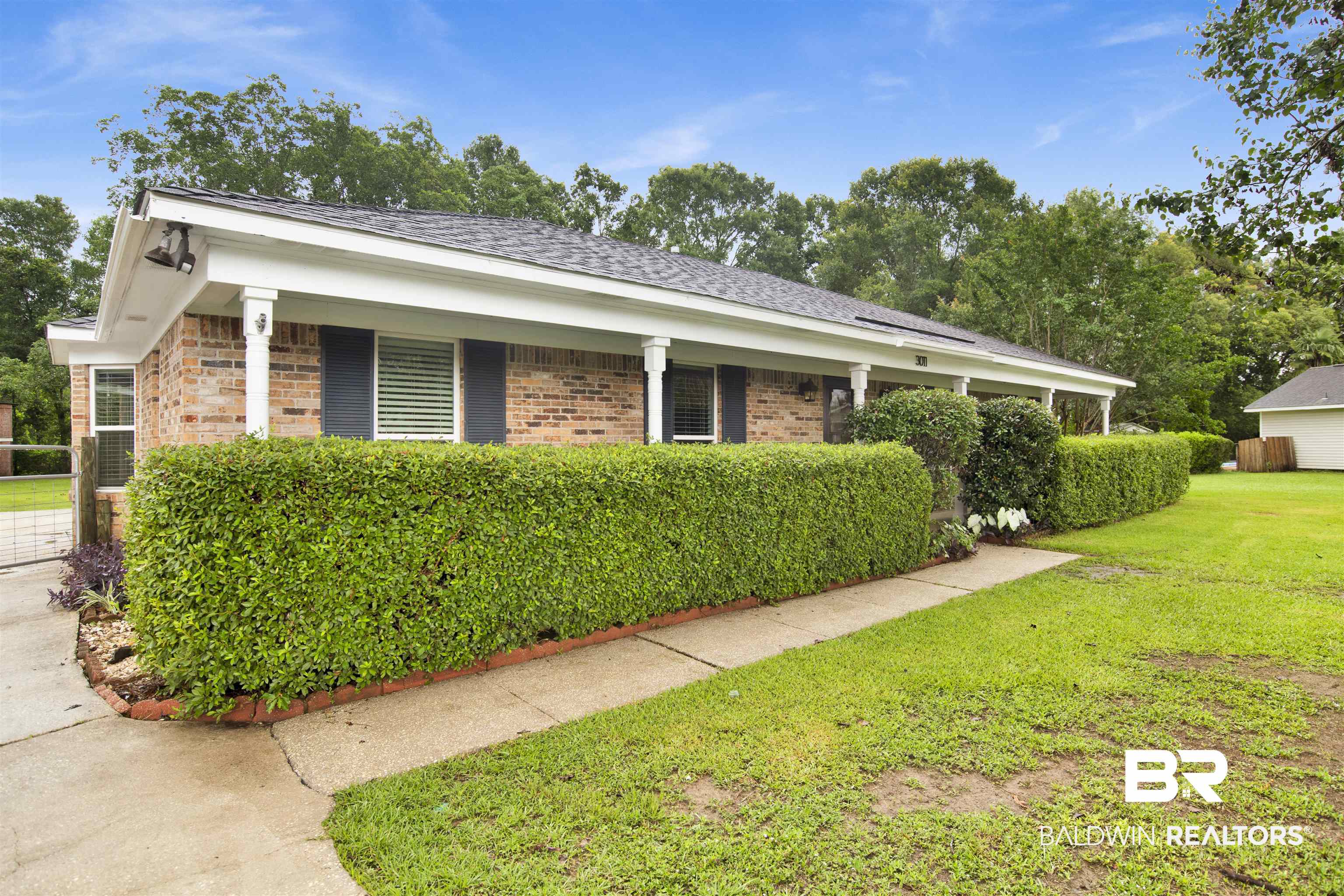 3011 Olde Gate Road Mobile, AL 36695 - Photo 4 of 35 View of side of property with a yard and brick siding