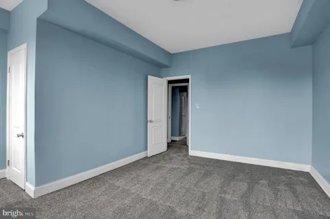 an empty room with windows and closet