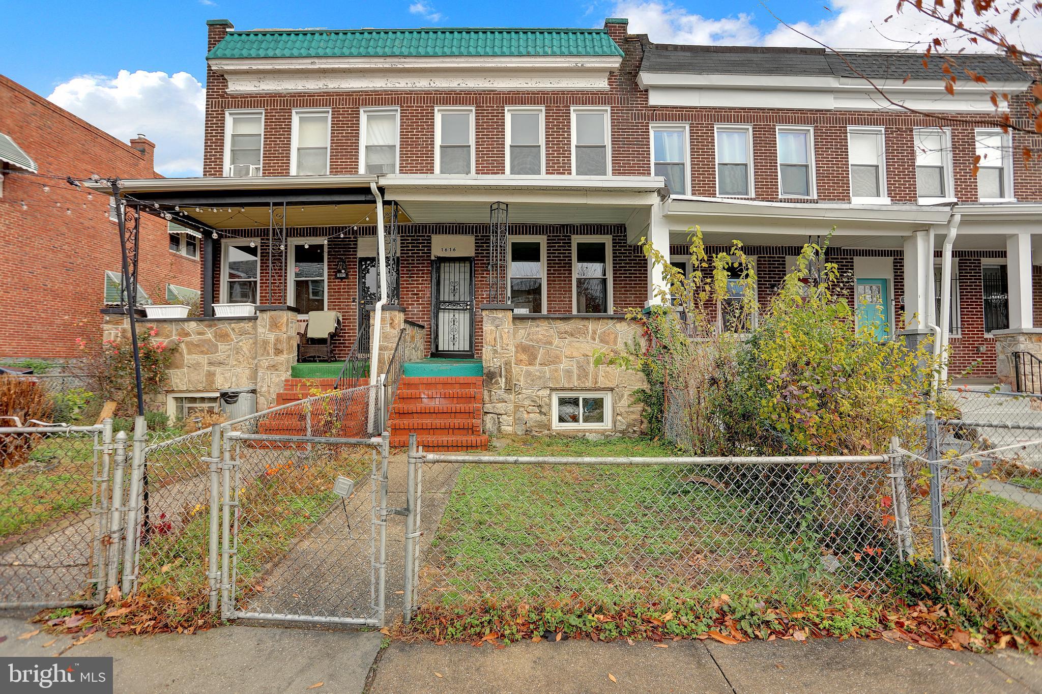 1616 Homestead Street Baltimore, MD 21218 - Photo 2 of 35 front view of a brick house with a yard