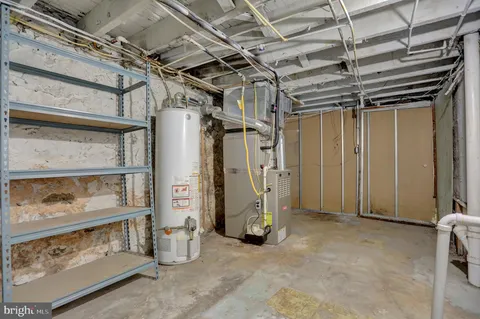 a view of a white building with a yard and plants