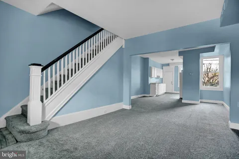a view of an empty room with stairs