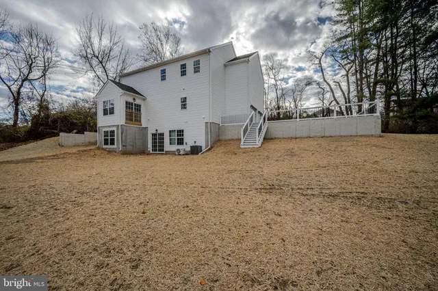 a view of a house with a yard covered in snow