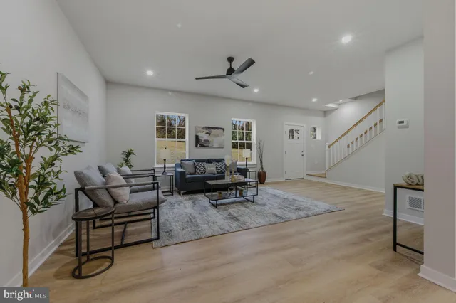 a living room with furniture and a potted plant