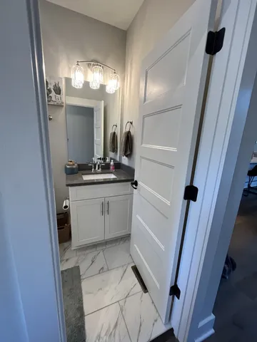 a bathroom with a sink a toilet a mirror and vanity