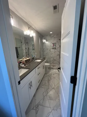 a bathroom with a sink a mirror and a shower