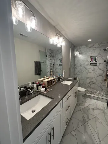 a bathroom with a double vanity sink and mirror