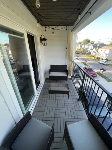 a view of balcony with wooden floor