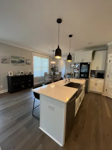 a kitchen with a stove and a wooden floor
