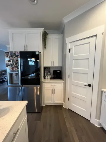 a kitchen with stainless steel appliances a refrigerator and a stove top oven