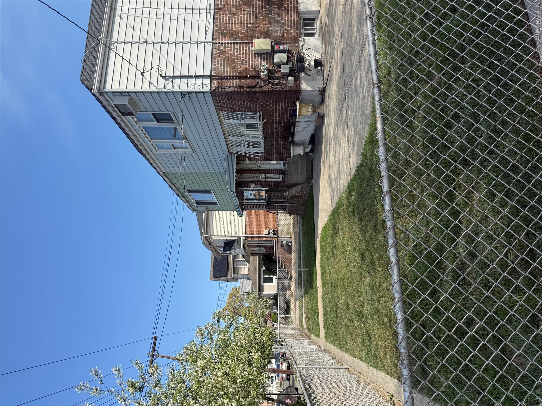 223-02 145th Road Queens, NY 11413 - Photo 3 of 6 a view of a house with a backyard
