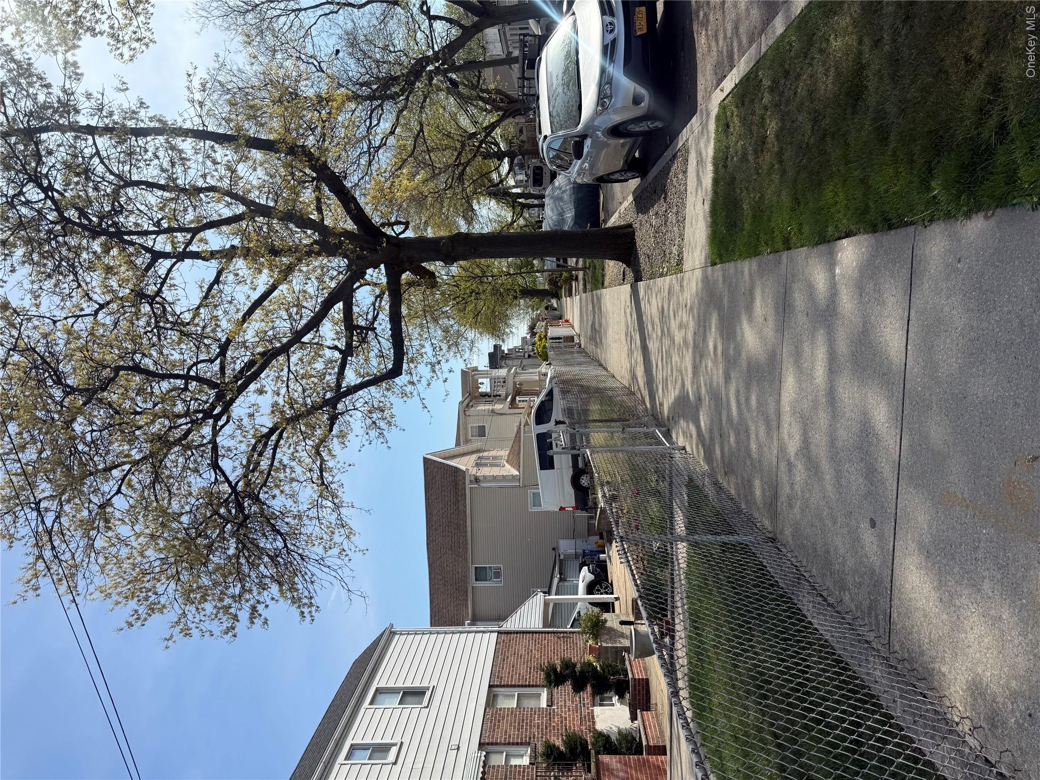 223-02 145th Road Queens, NY 11413 - Photo 6 of 6 a view of a yard with cars parked