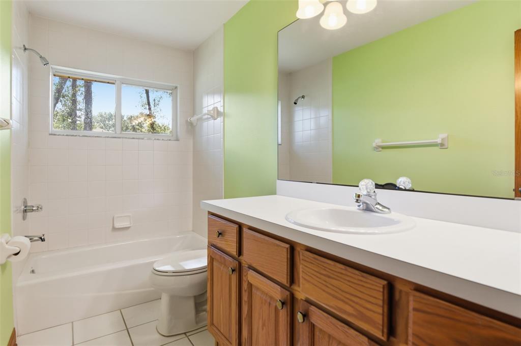 2409 South Spring Garden Avenue DeLand, FL 32720 - Photo 16 of 26 a bathroom with a sink a toilet and shower
