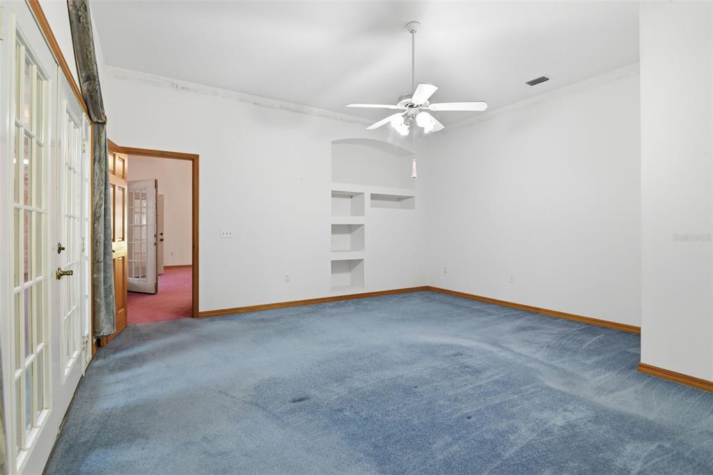 2409 South Spring Garden Avenue DeLand, FL 32720 - Photo 18 of 26 an empty room with chandelier fan and windows