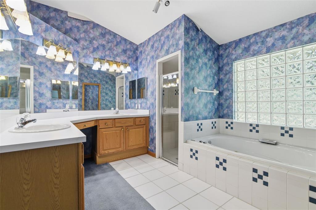 2409 South Spring Garden Avenue DeLand, FL 32720 - Photo 19 of 26 a spacious bathroom with a sink double vanity granite and a large mirror