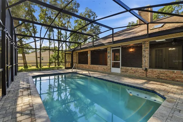 a view of a backyard with a swimming pool