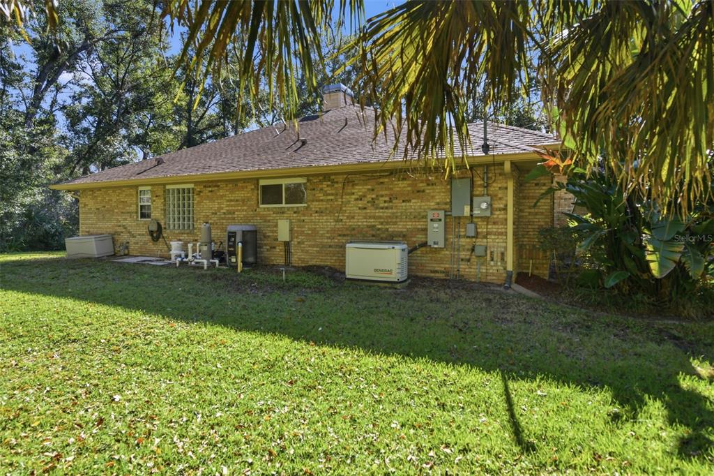 2409 South Spring Garden Avenue DeLand, FL 32720 - Photo 25 of 26 a view of a patio with table and chairs under an umbrella
