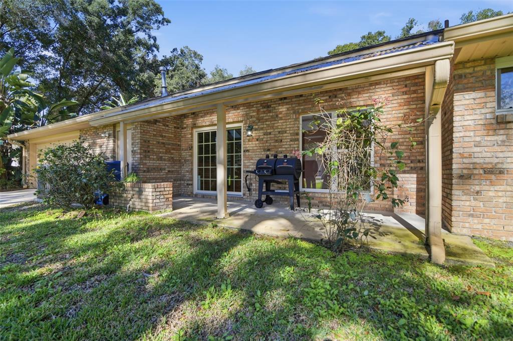 2409 South Spring Garden Avenue DeLand, FL 32720 - Photo 5 of 26 a view of a chair and table in backyard of the house
