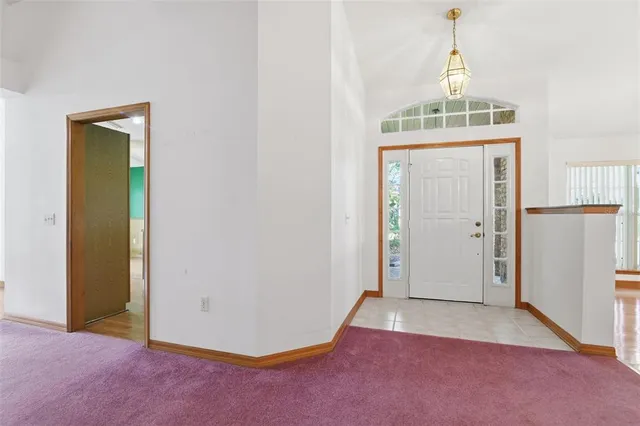 an empty room with closet and windows