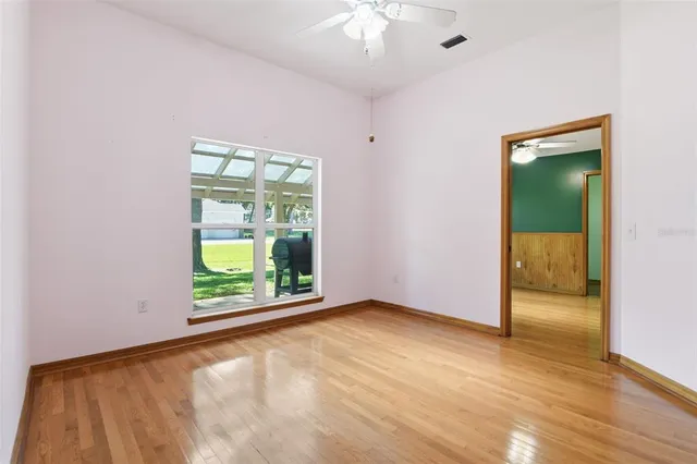 wooden floor in an empty room with a window