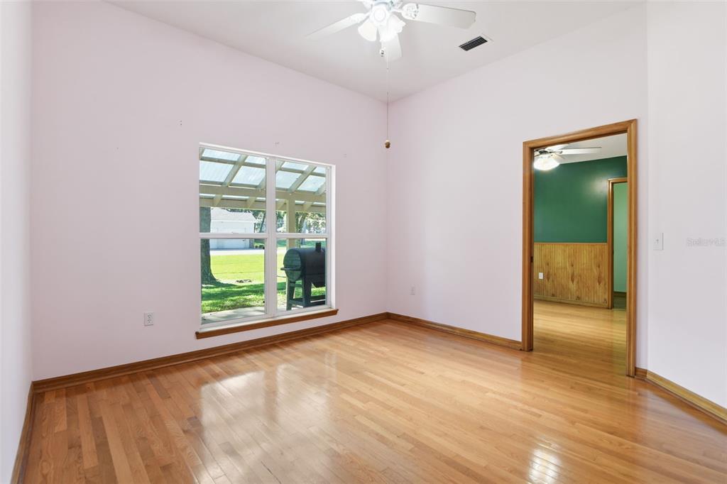 2409 South Spring Garden Avenue DeLand, FL 32720 - Photo 7 of 26 wooden floor in an empty room with a window