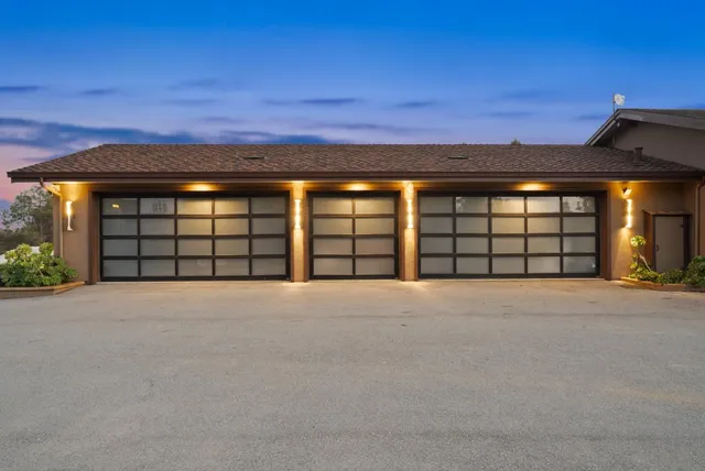 a living room with fireplace furniture and a large window