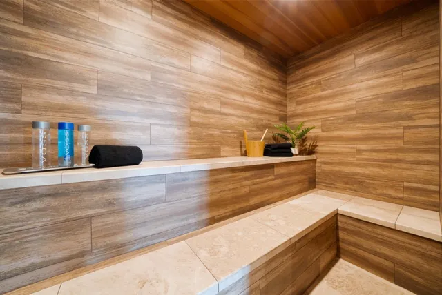 a bedroom with a large bed and a potted plant