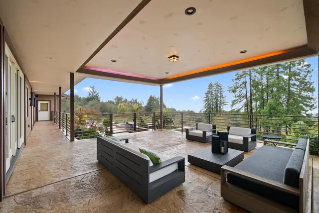 a view of a house with backyard water fountain and sitting area