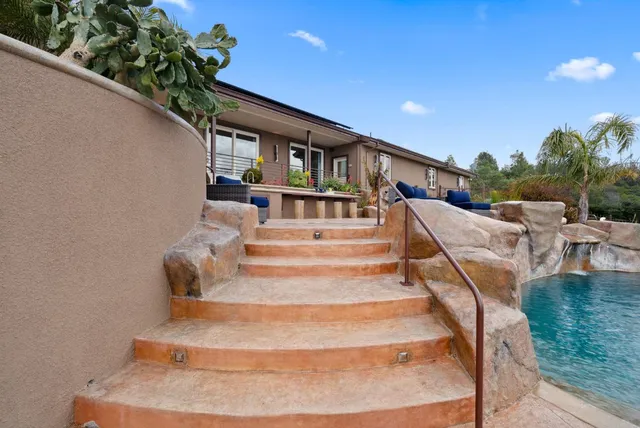 a outdoor living space with patio furniture and garden view
