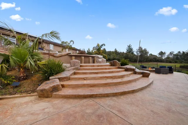a view of a backyard with sitting area