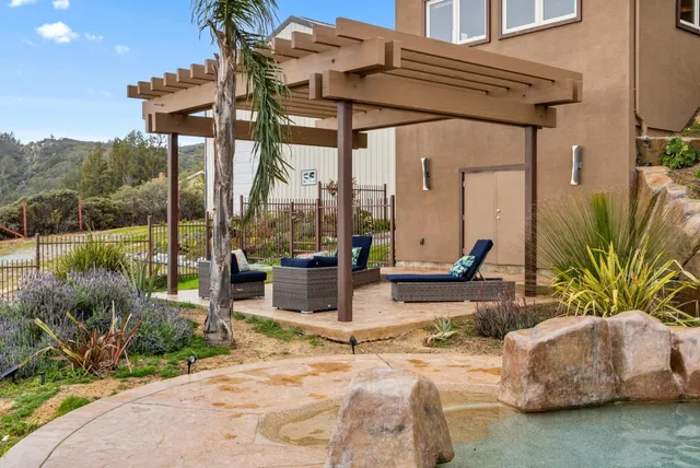 a aerial view of a house with a yard and trees