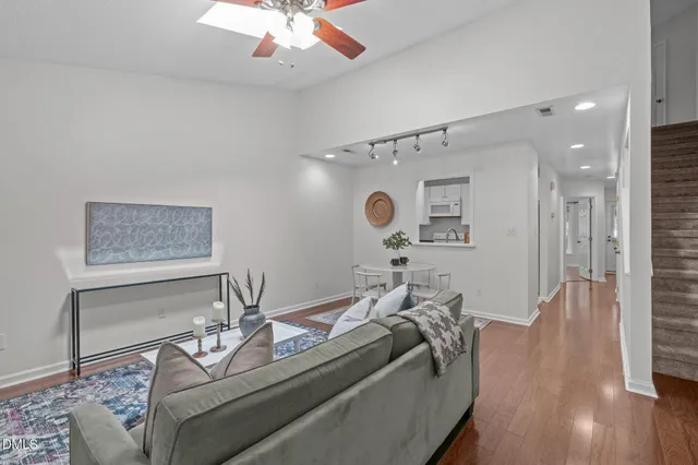 a living room with furniture a fireplace and a potted plant