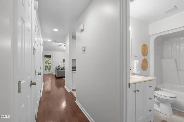 a view of an empty room with wooden floor