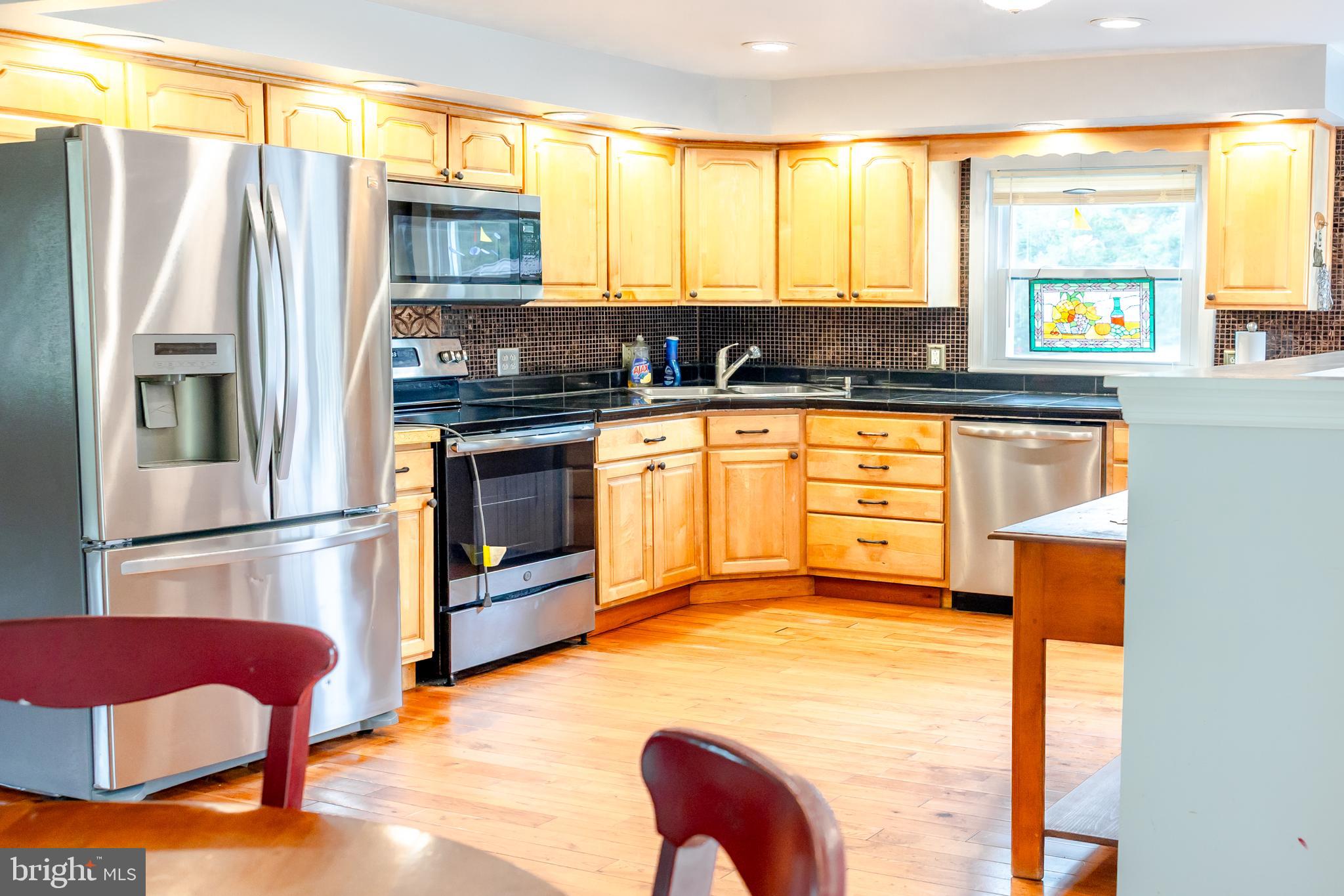 41 Plymouth Road Sicklerville, NJ 08081 - Photo 3 of 30 a kitchen with stainless steel appliances granite countertop a stove a refrigerator and a microwave