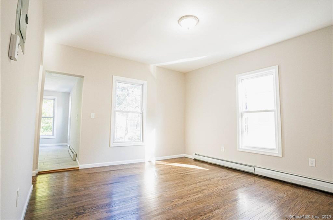 34 Sisson Avenue Hartford, CT 06106 - Photo 21 of 35 an empty room with wooden floor and windows