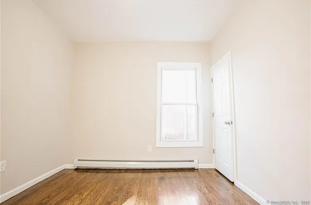a view of an empty room and wooden floor