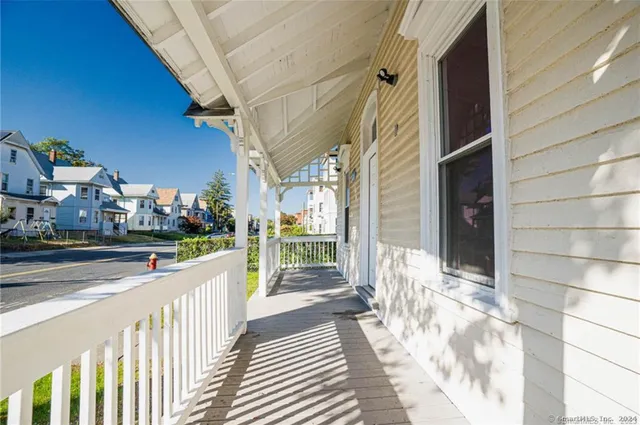 a view of a white house with large windows
