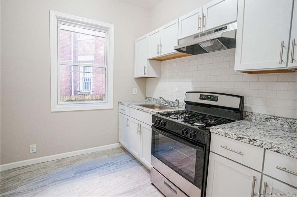 34 Sisson Avenue Hartford, CT 06106 - Photo 10 of 35 a stove top oven sitting inside of a kitchen