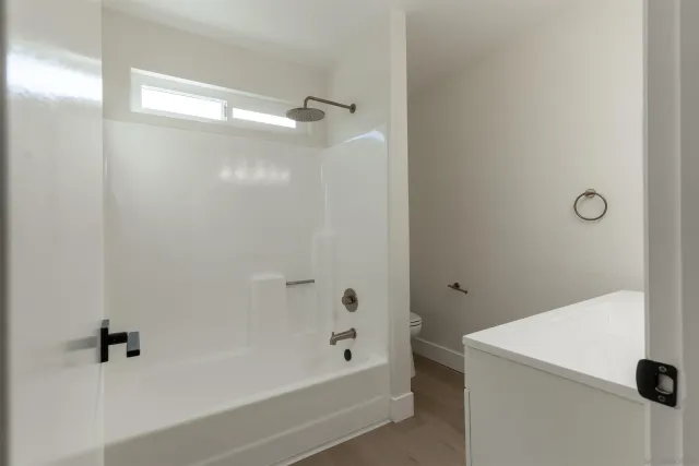 a kitchen with granite countertop a refrigerator and a sink